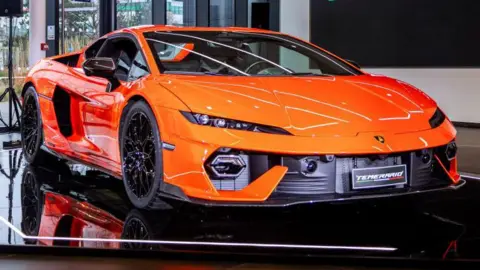 Lamborghini swerves away from all-electric future Getty A bright orange Lamborghini Temerario parked in a showroom