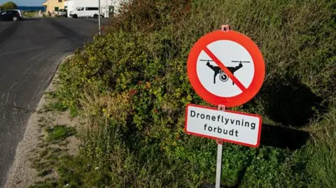 What's the best way to detect and destroy drones? AFP via Getty Images In Denmark, a round sign picturing a drone with a red stripe through it, indicating a zone where drone flying is prohibited.