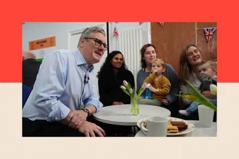 PA Wire Prime Minister Sir Keir Starmer speaks with guests during a visit to the Benn Partnership Centre