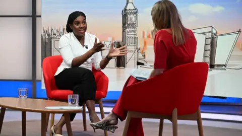 Jeff Overs/BBC/PA Wire Kemi Badenoch in the Laura Kuenssberg studio, wearing a white top, a black skirt and cream shoes