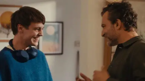 John Lewis A son and father looking at each other and smiling in the John Lewis advert