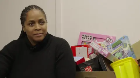 Brixton Soup Kitchen prepares for busy Christmas Jennifer Wilson sat in front of a pile of donated toys.