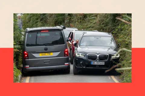 Getty Images Vehicles try to squeeze past each other in the narrow road and lanes at Porthcurno in Cornwall, England
