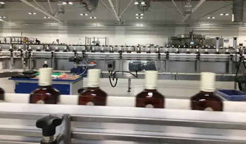 Whisky industry faces a bleak mid-winter as tariffs bite and exports stall Whisky bottles on a production line at a bottling plant