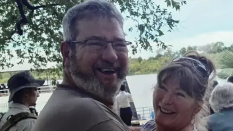 Sarah Armstrong Jono and Sarah Armstrong with their arms around one another both looking at the camera and smiling