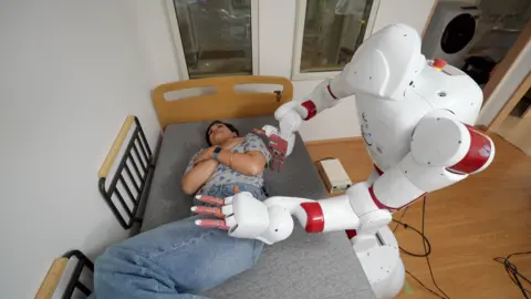 BBC AIREC robot turning over a person at Waseda University in Tokyo