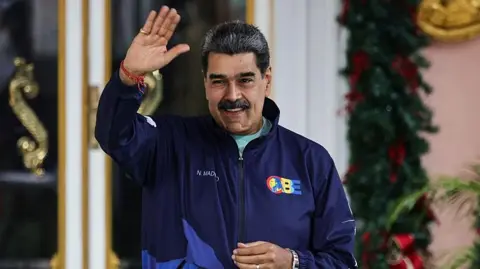 AFP via Getty Images President of Venezuela Nicolás Maduro gestures during a march as part of the "Venezuelan Student Day" at Miraflores on November 21, 2025 in Caracas, Venezuela.
