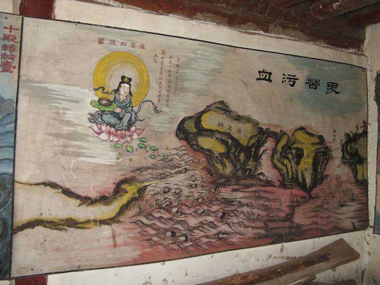 A painting showing the heads of women in a pond of blood with a bodhisattva, seated on a lotus, floating above them.